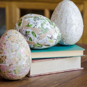 Decoupage Easter eggs sitting on old books