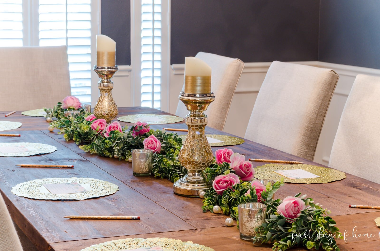 Wedding shower decorations with eucalyptus garland, fresh roses, candlesticks, mercury glass votives and DIY bridal shower advice cards