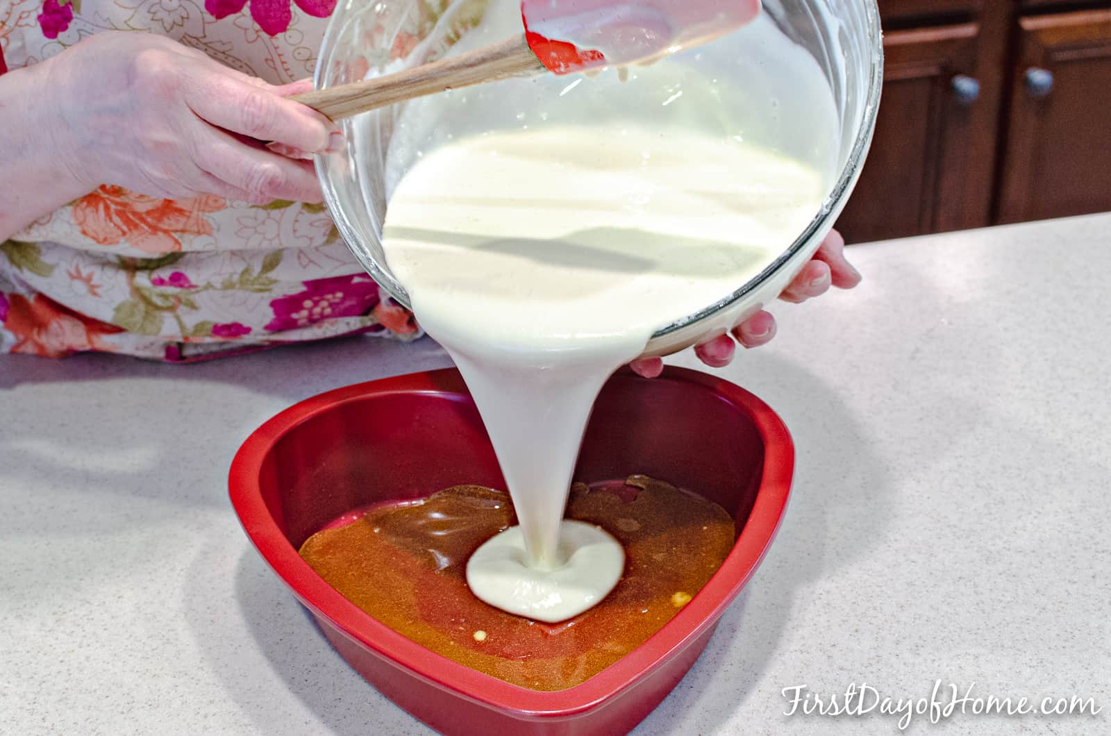 Pouring cheesecake batter into heart shaped cake pan for cheesecake flan recipe