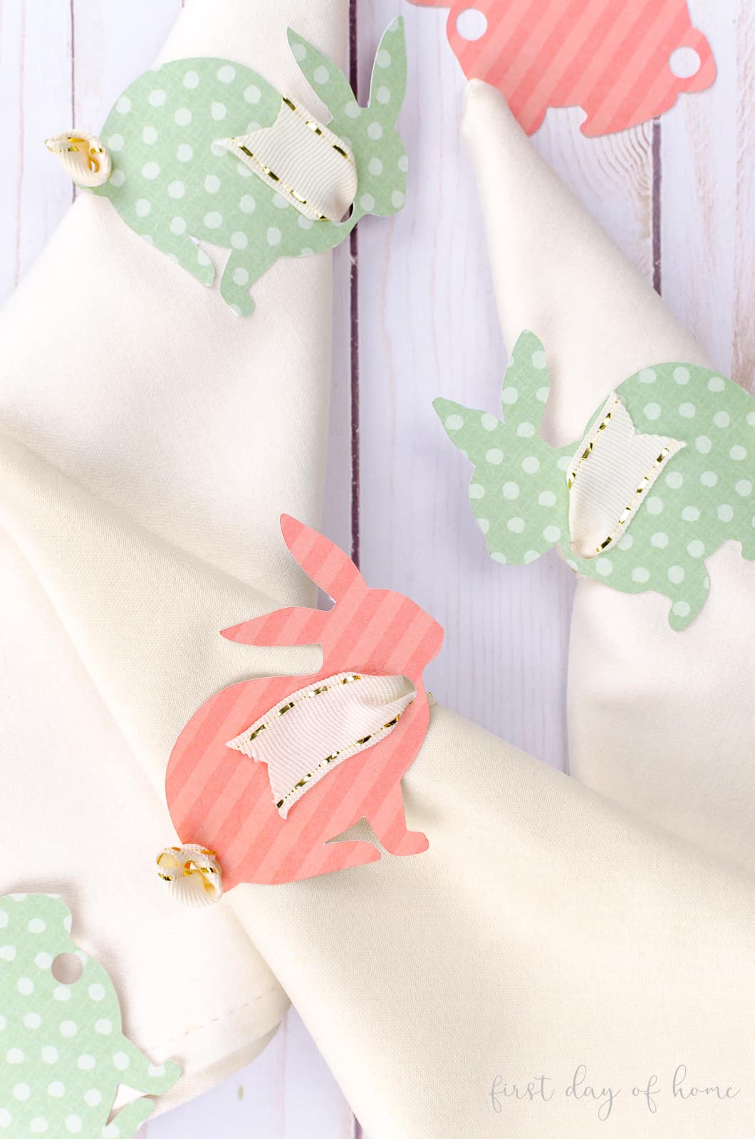 Pink and green bunny napkin rings using scrapbook paper and grosgrain ribbon for Easter tablescape