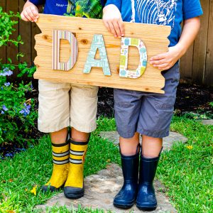 Decoupage wood signs tutorial with "Dad" DIY decoupage sign on wooden background