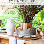 Fall outdoor dining table decor with copper mugs, copper ice bucket, woven placemats and DIY grain sack towels with tall fall centerpiece