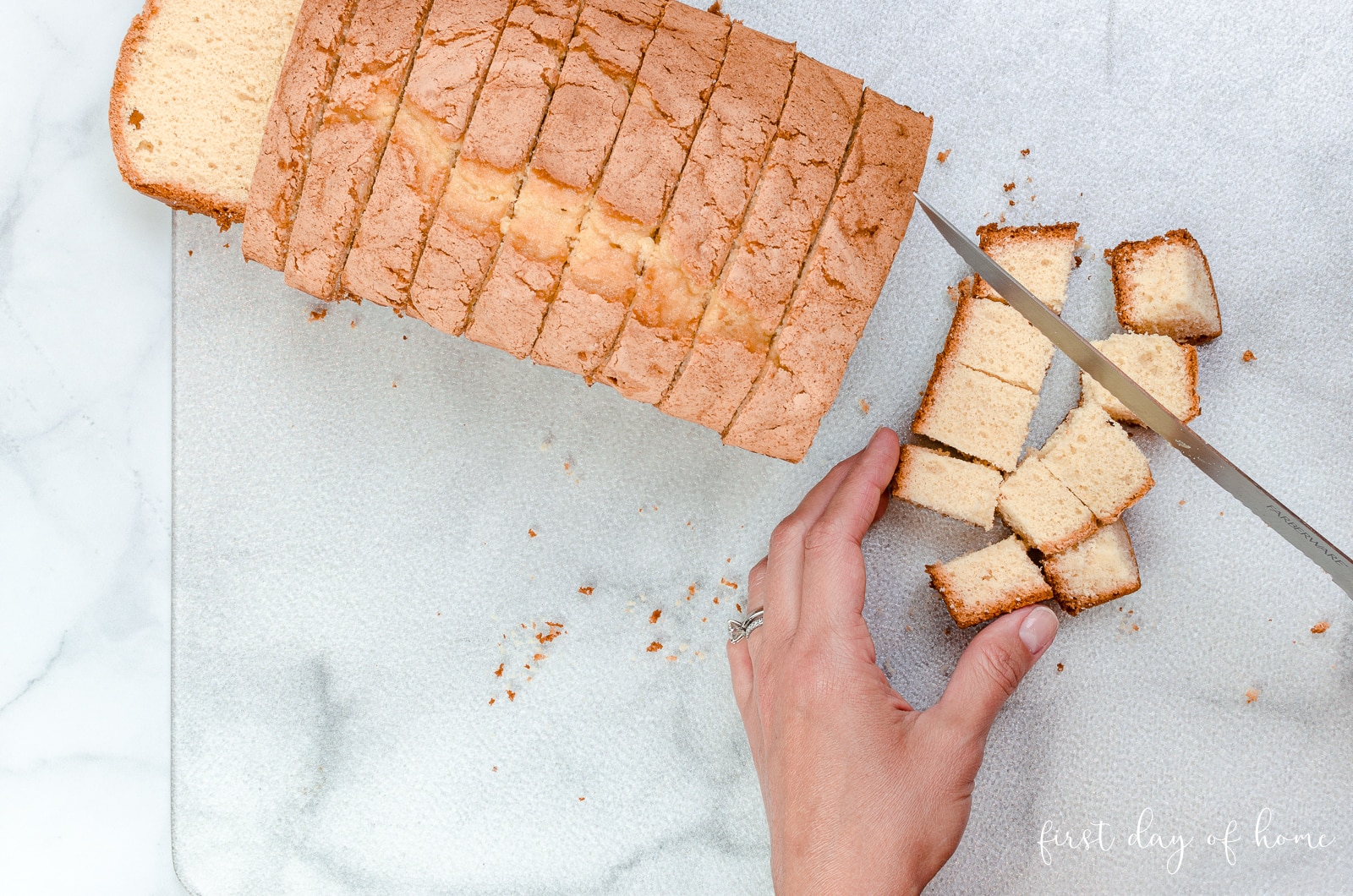 Cutting pound cake into squares for strawberry trifle dessert