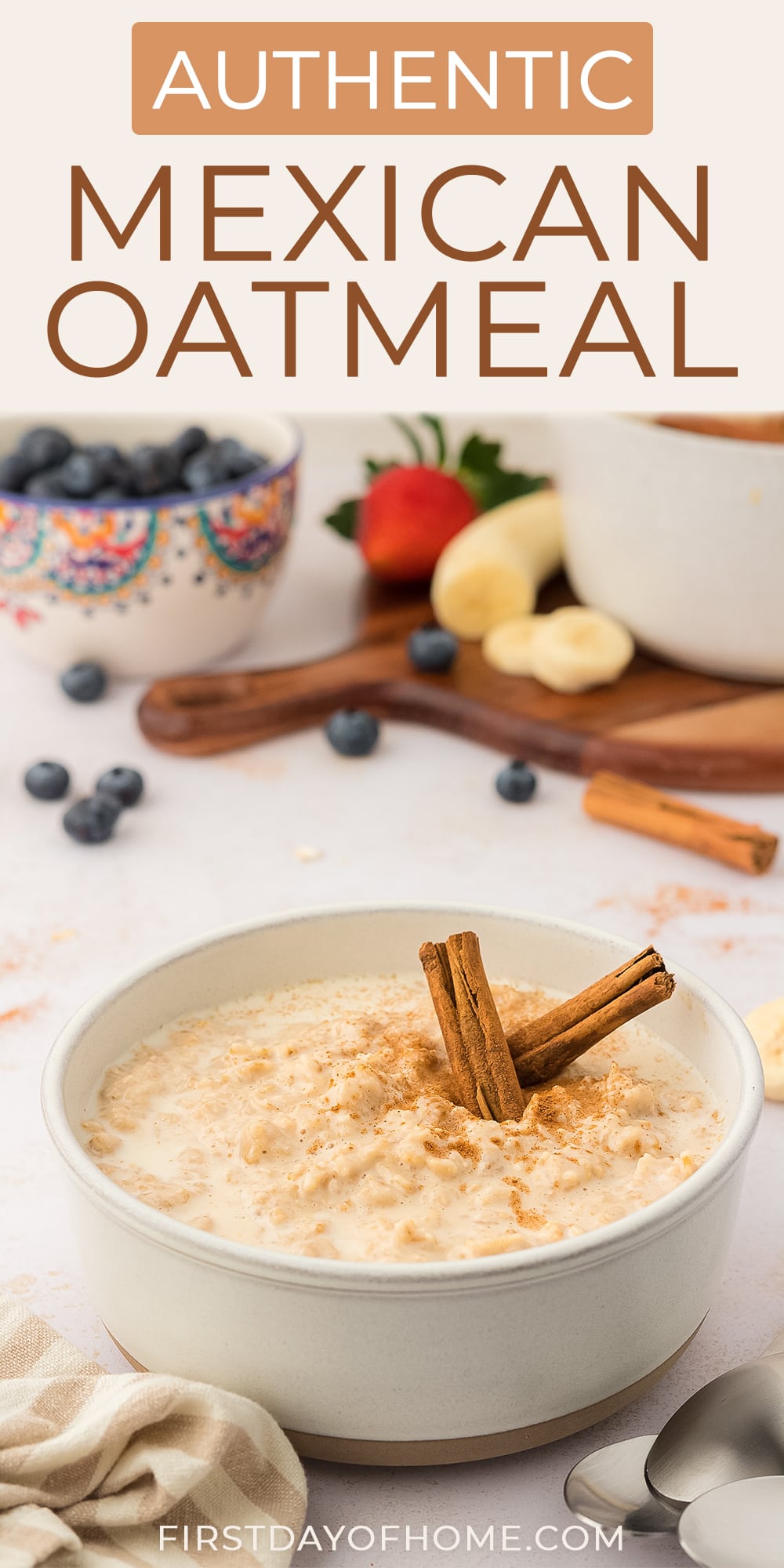 Bowl of Mexican oatmeal (avena) shown with cinnamon sticks and fruit in the background
