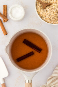 Boiling cinnamon sticks to make Mexican oatmeal (avena)