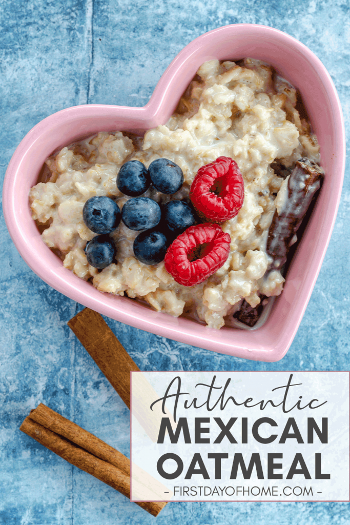Mexican oatmeal (avena) in heart-shaped dish with blueberries, raspberries and cinnamon sticks