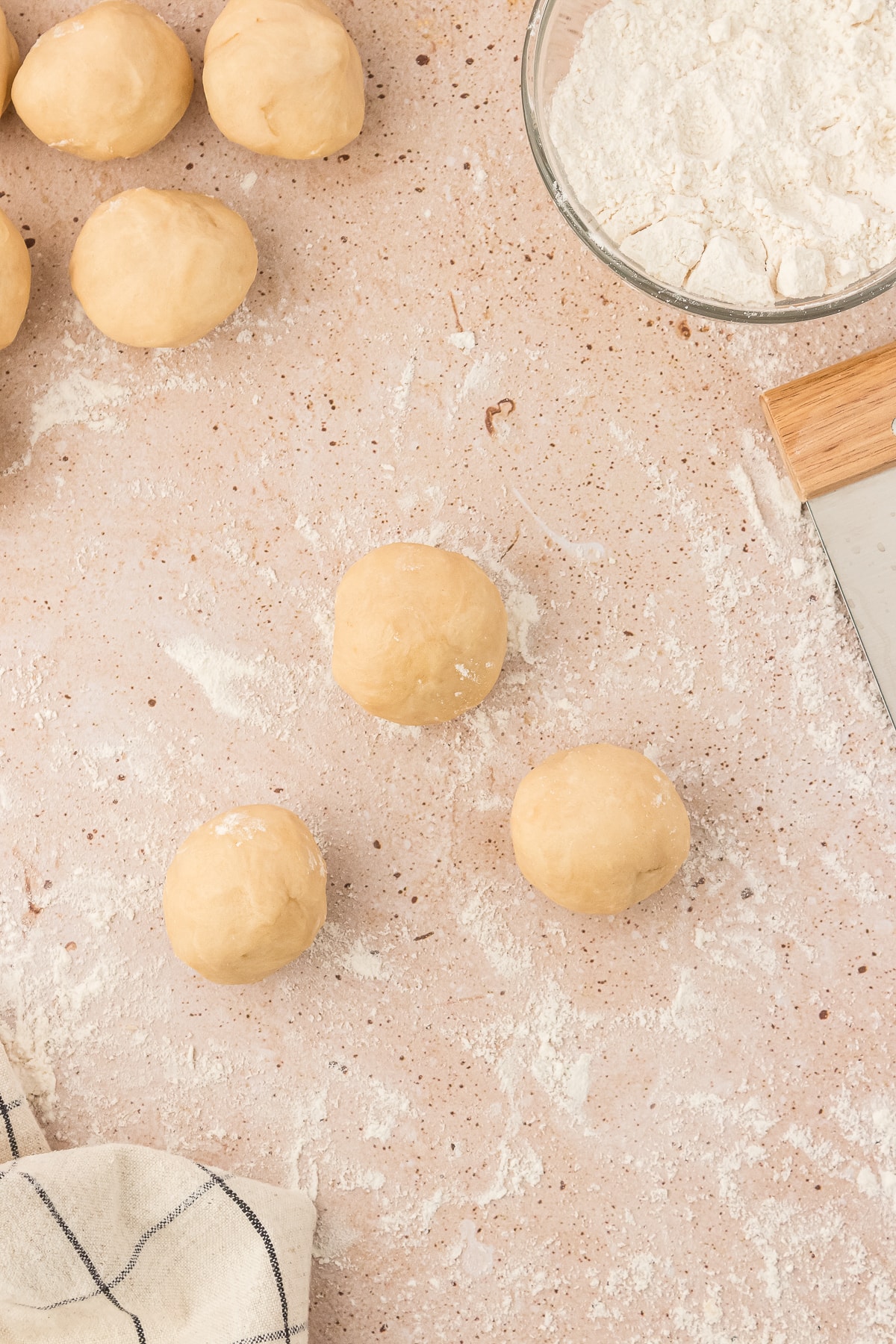 Empanada dough rolled into balls to form empanada shape