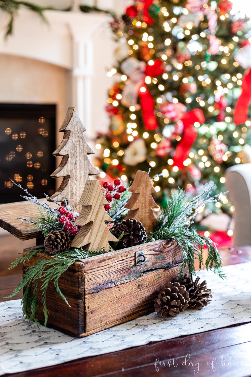 Christmas centerpiece with wooden crate, cedar garland and wooden trees