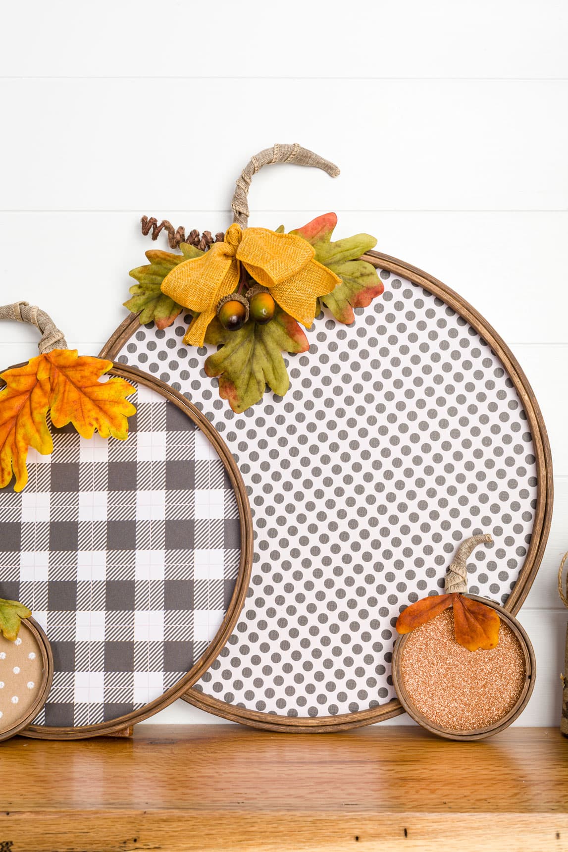 Fall paper hoop decorations that look like pumpkins in various patterns