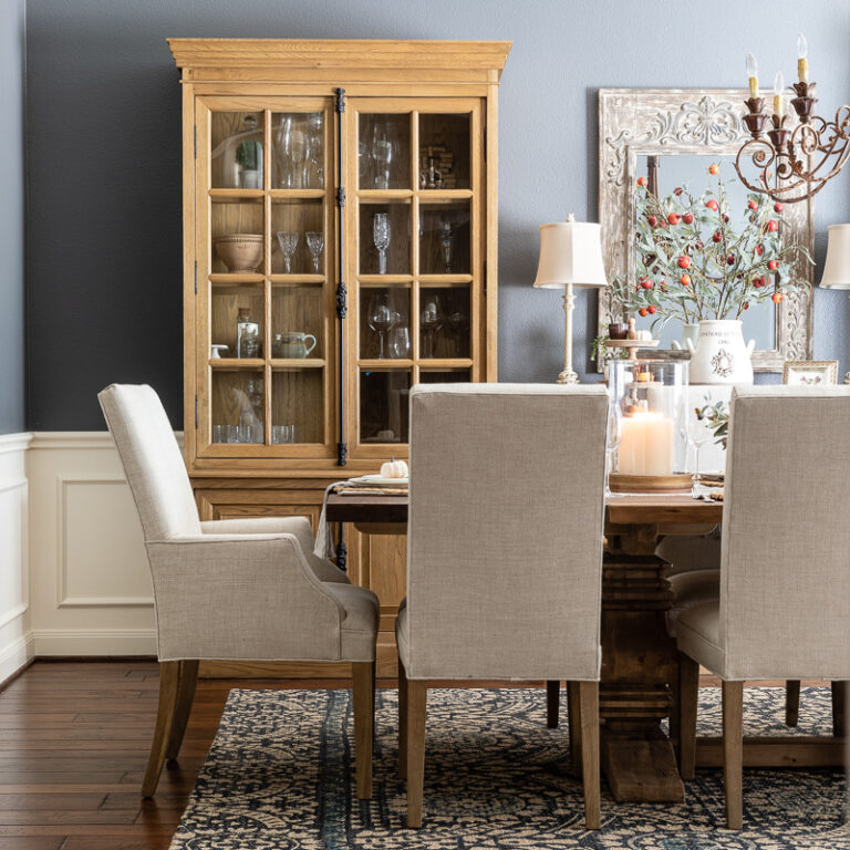 Fall dining room with wood cabinets and linen colored chairs