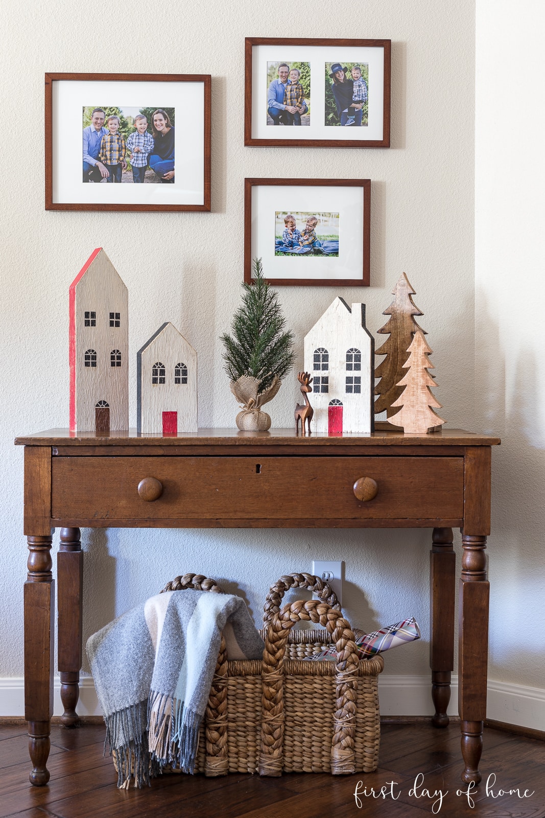 Christmas village with wooden houses and wooden trees on table