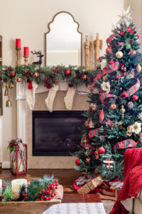 Christmas decor in living room with Christmas tree in front and Christmas mantel in back