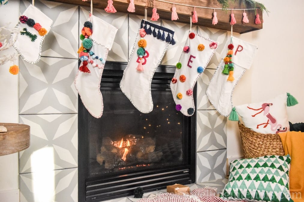 Boho Christmas mantel with colorful pom-pom stockings