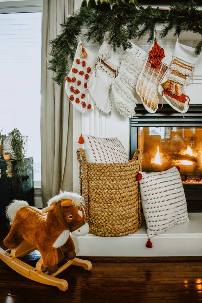 Boho style Christmas mantel with DIY stockings and rocking horse decor