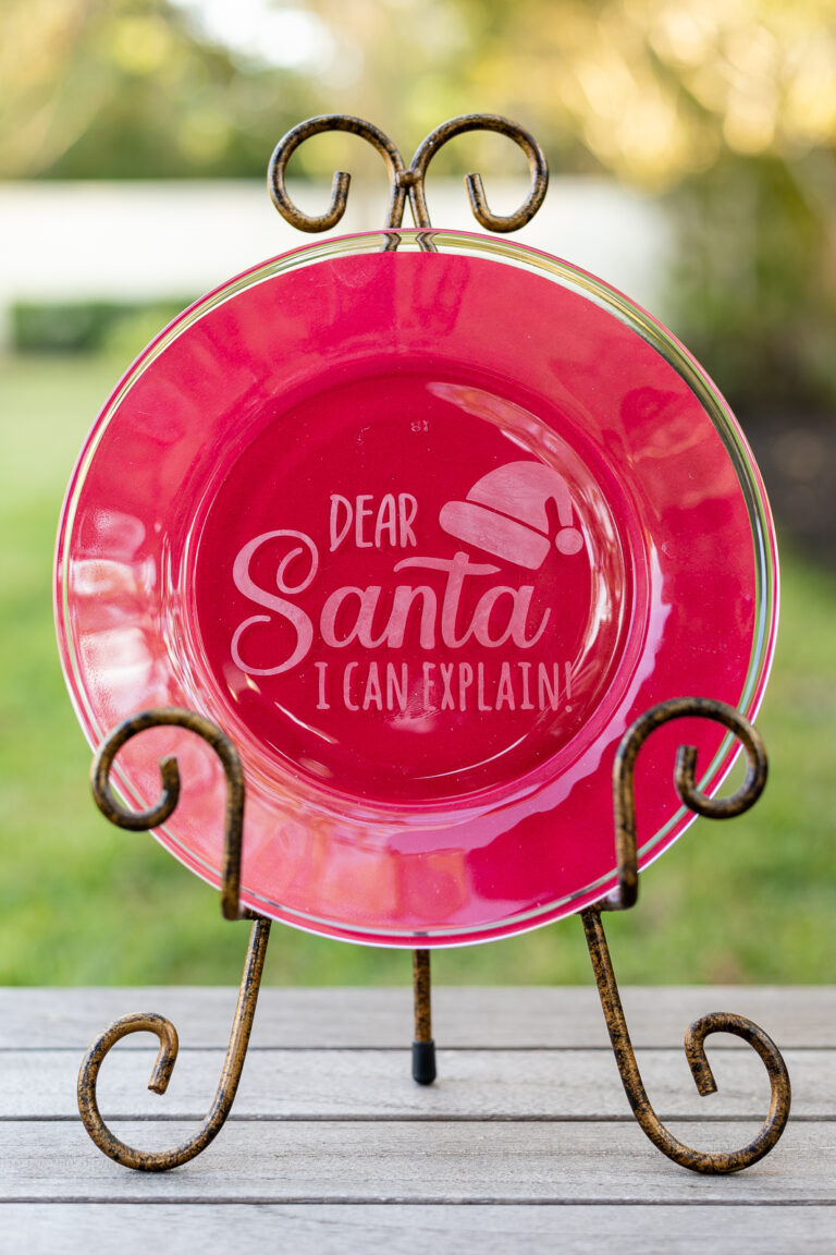Etched glass plate on stand with phrase "Dear Santa, I Can Explain"