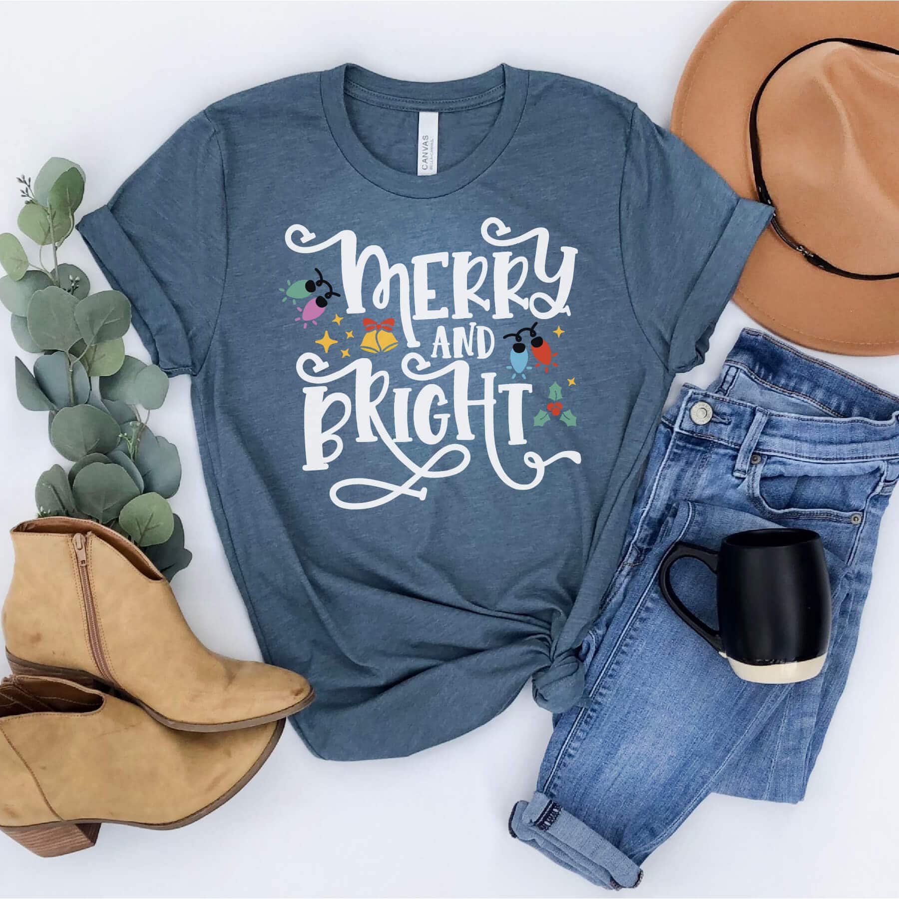 Christmas t-shirt with phrase "Merry and Bright" surrounded by Christmas lights, bells and stars.