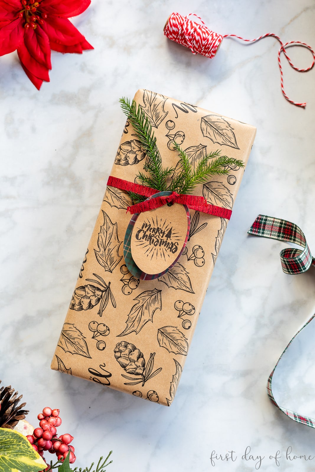 Christmas gift wrapped in patterned kraft paper with Merry Christmas gift tag