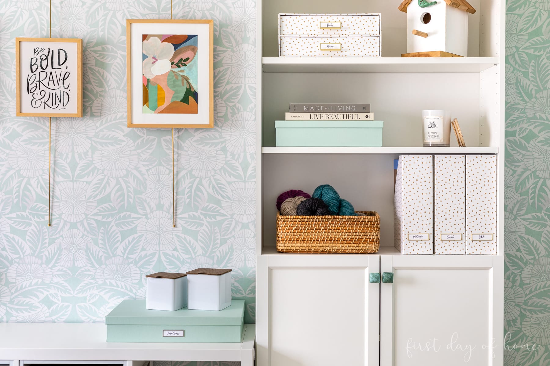 Craft room wallpaper closeup with hanging frames and styled bookcase