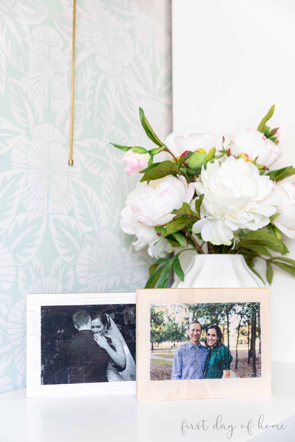 Photo transfers on wood in front of faux floral arrangement