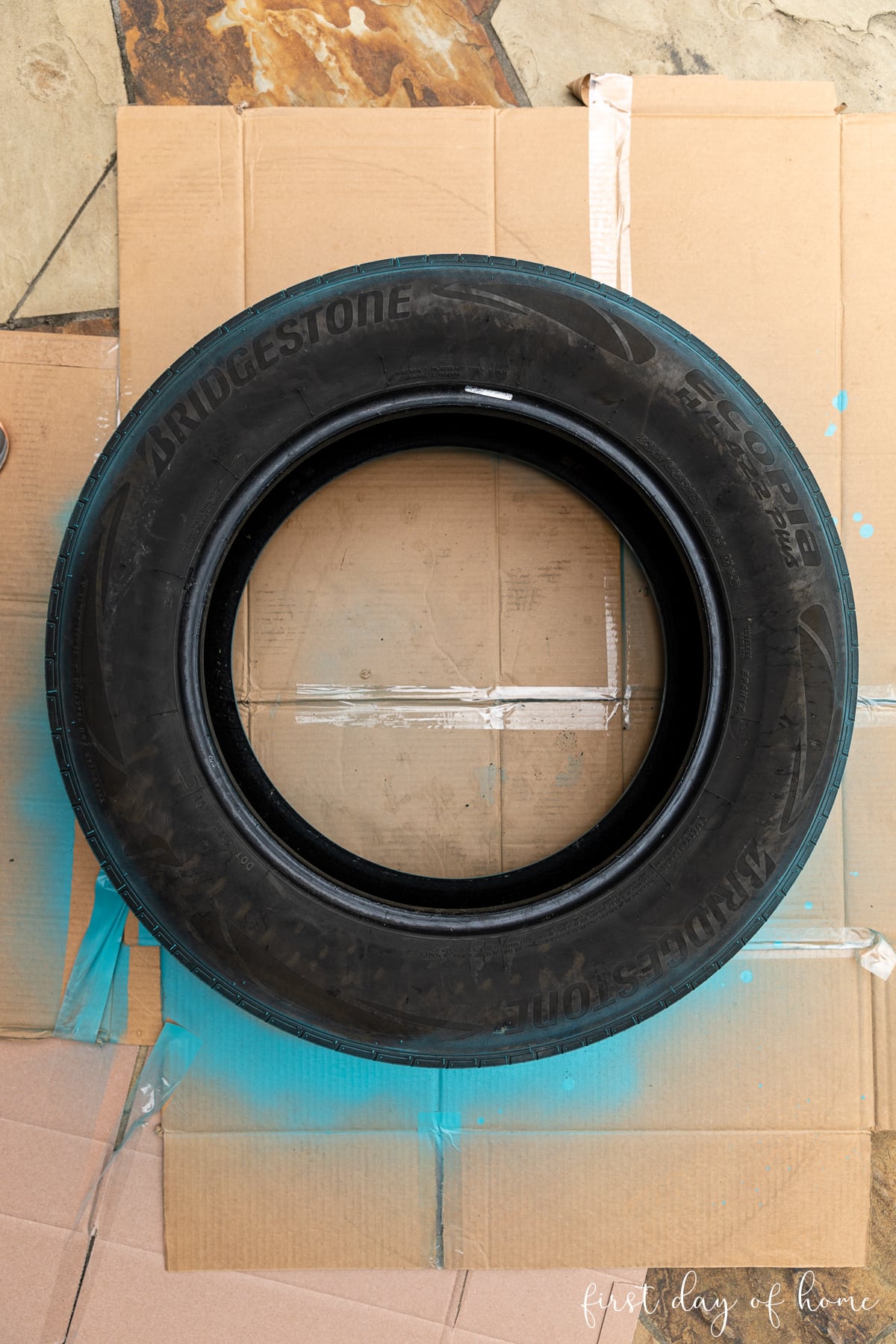 Rubber tire lying on ground after cleaning, before spray painting