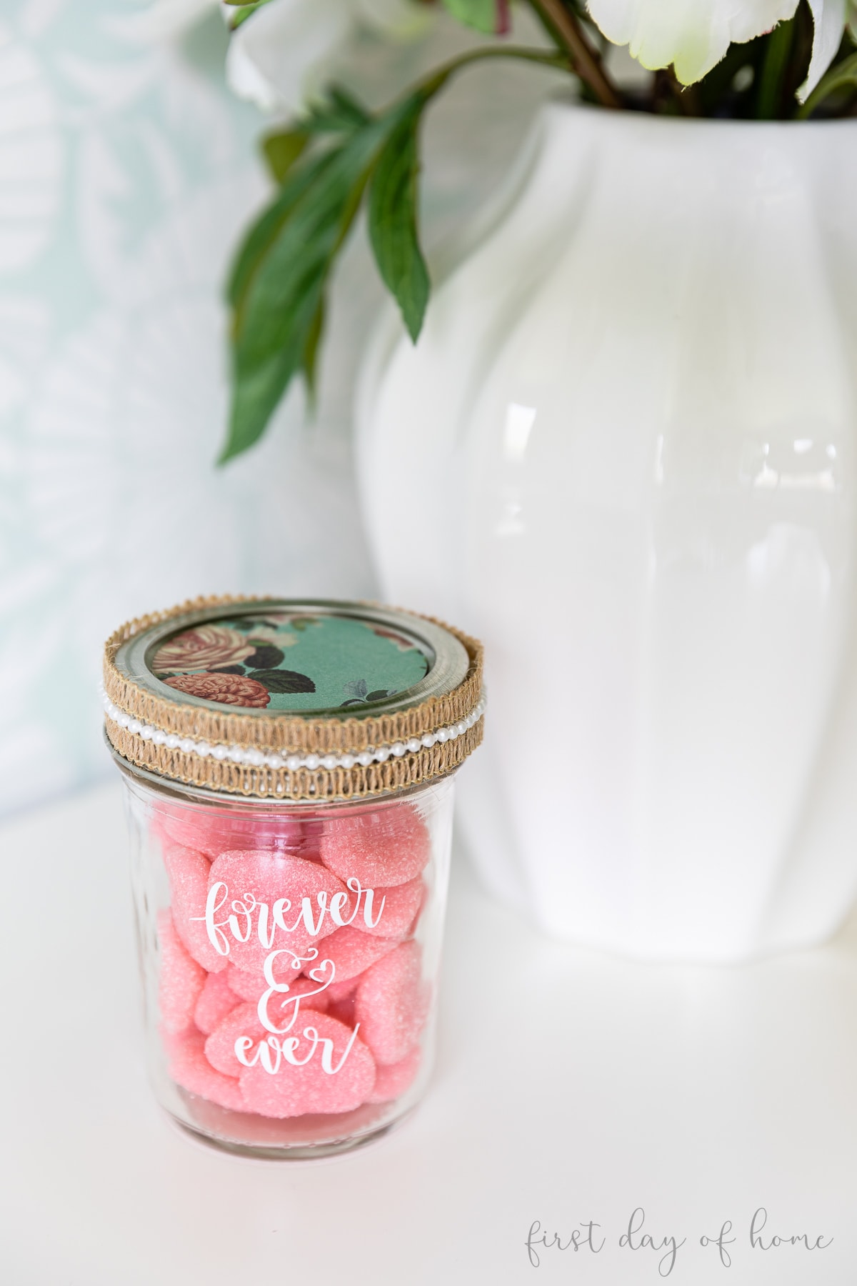 Mason jar filled with pink gummy candies labeled with Cricut vinyl words