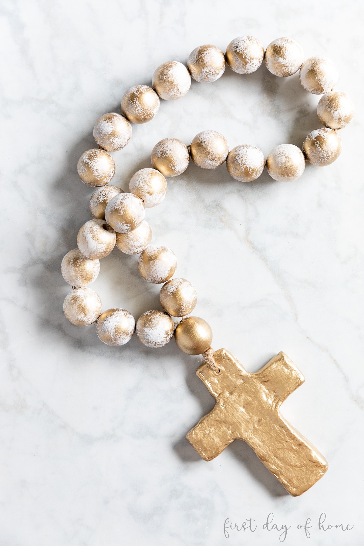 DIY bead garland with a clay cross attached