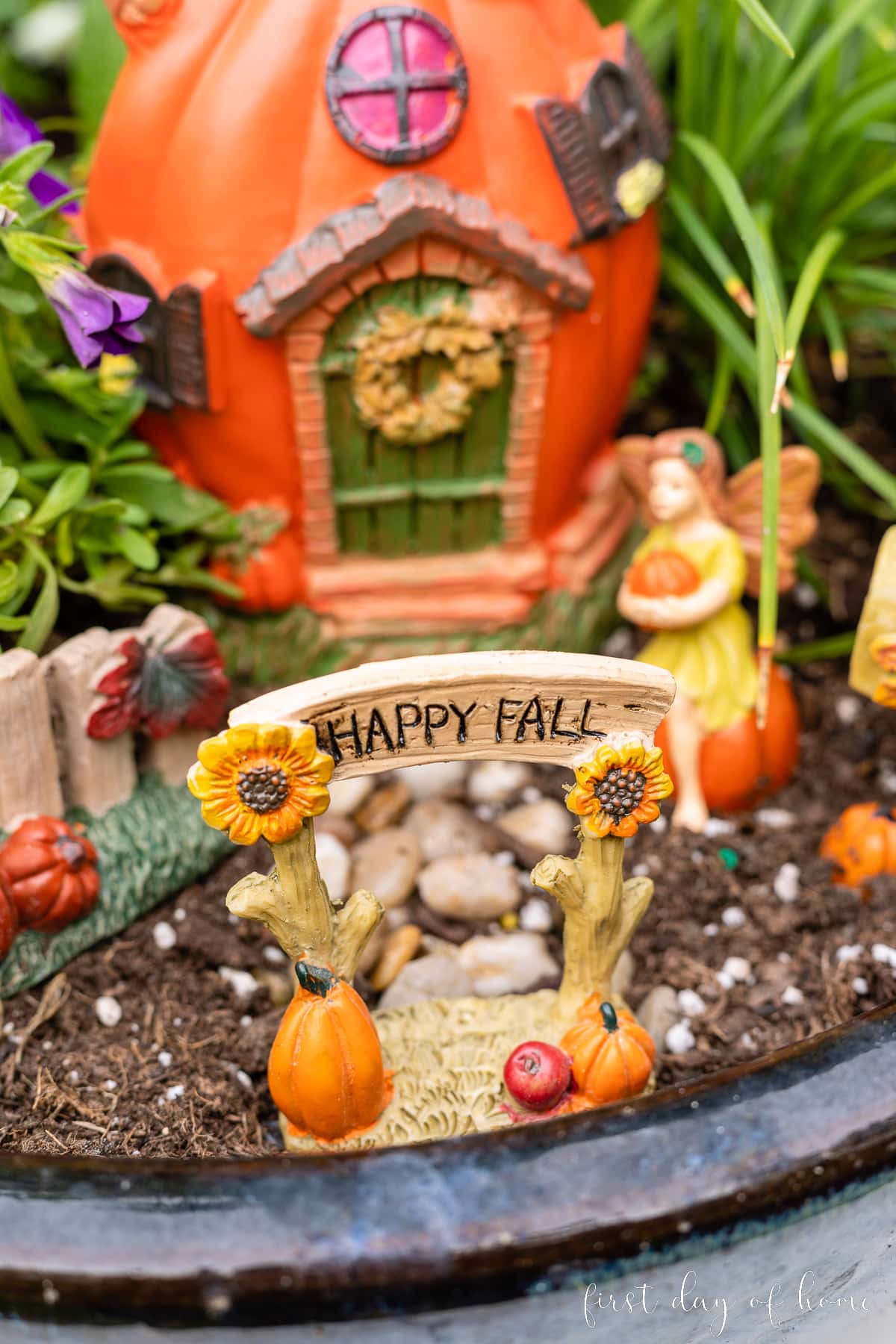Closeup of Dollar Tree figurines with archway that reads "Happy Fall"