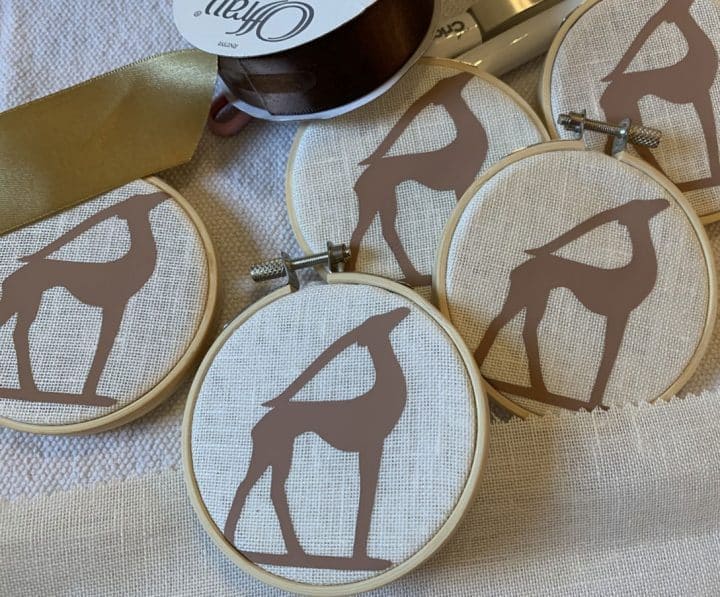 Round Christmas ornament with decal silhouette of deer made with Cricut by The Honeycomb Home