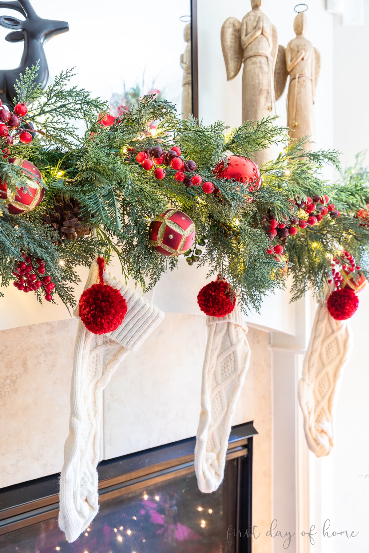 Knit stockings hung from Christmas mantel garland