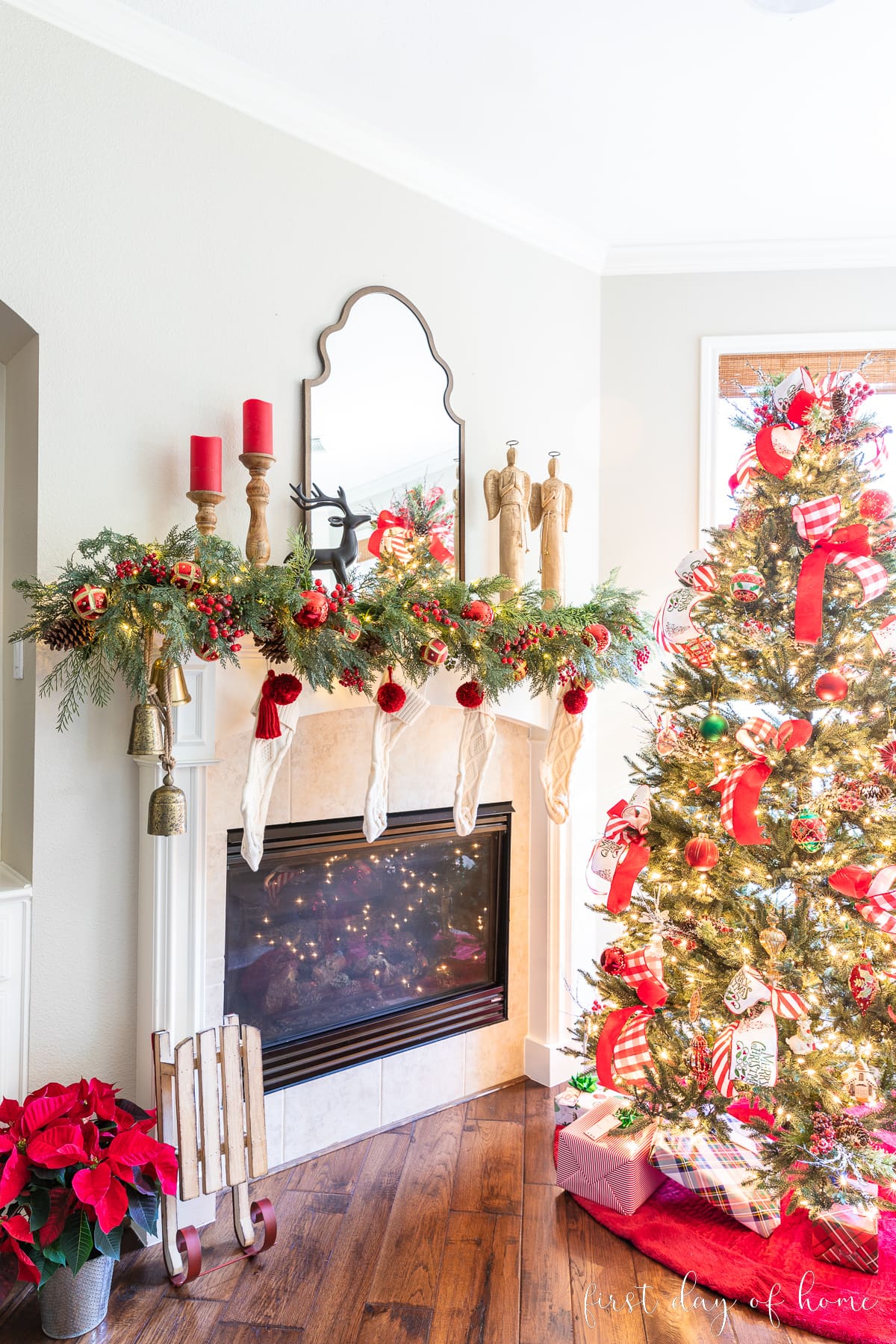 View of Christmas mantel decor and Christmas tree from a side angle