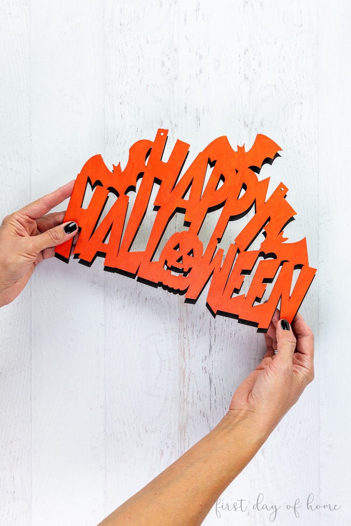 Wooden cutout with phrase "Happy Halloween."
