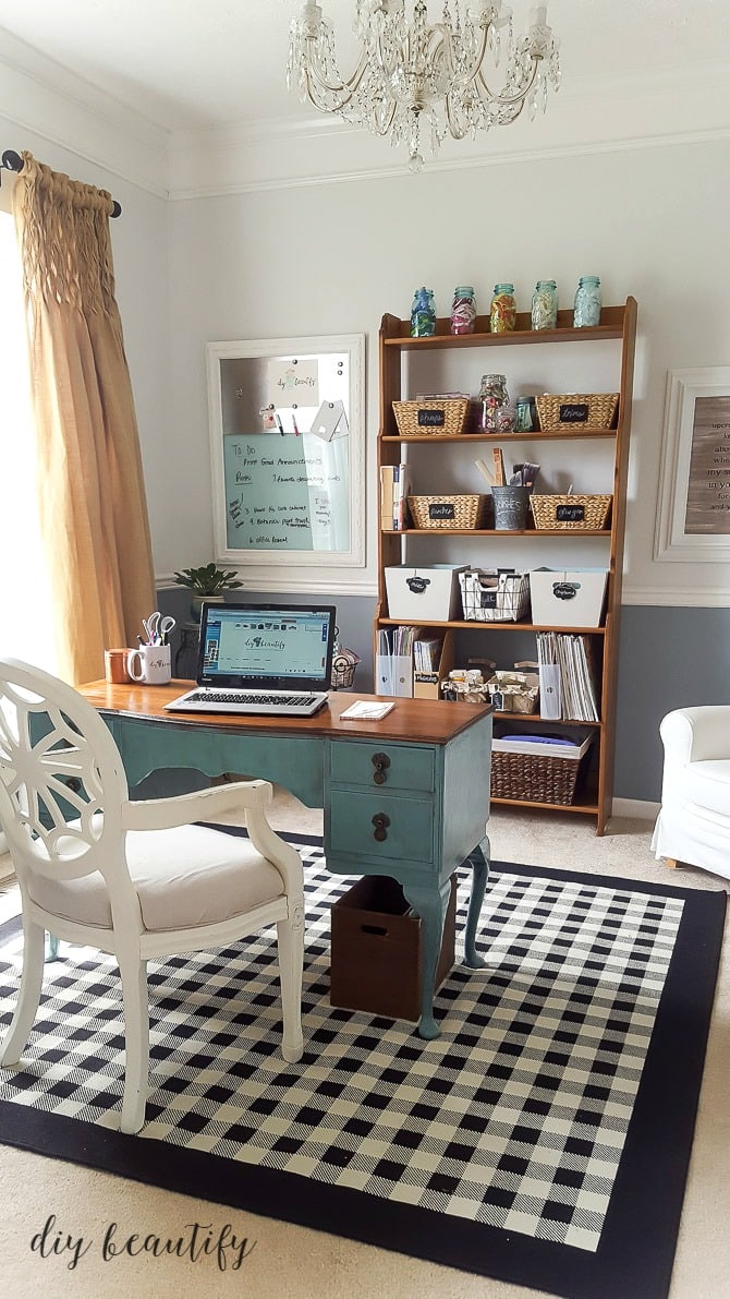 Craft room office with desk, bookcase, and magnetic bulletin board