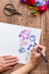 Adding fine details to pounded flower art with calligraphy pen