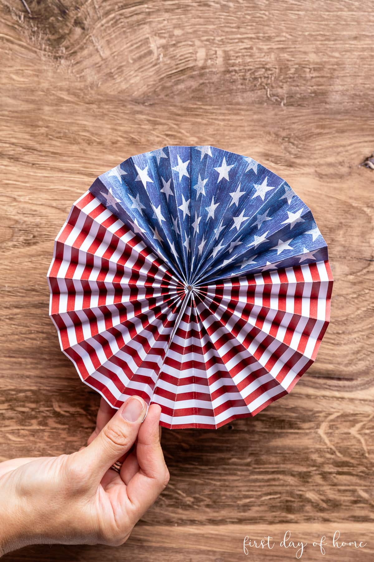 Patriotic paper fan with stars and stripes pattern