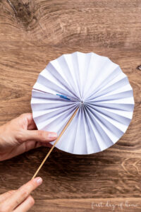 Using paper clips to secure paper fans in back
