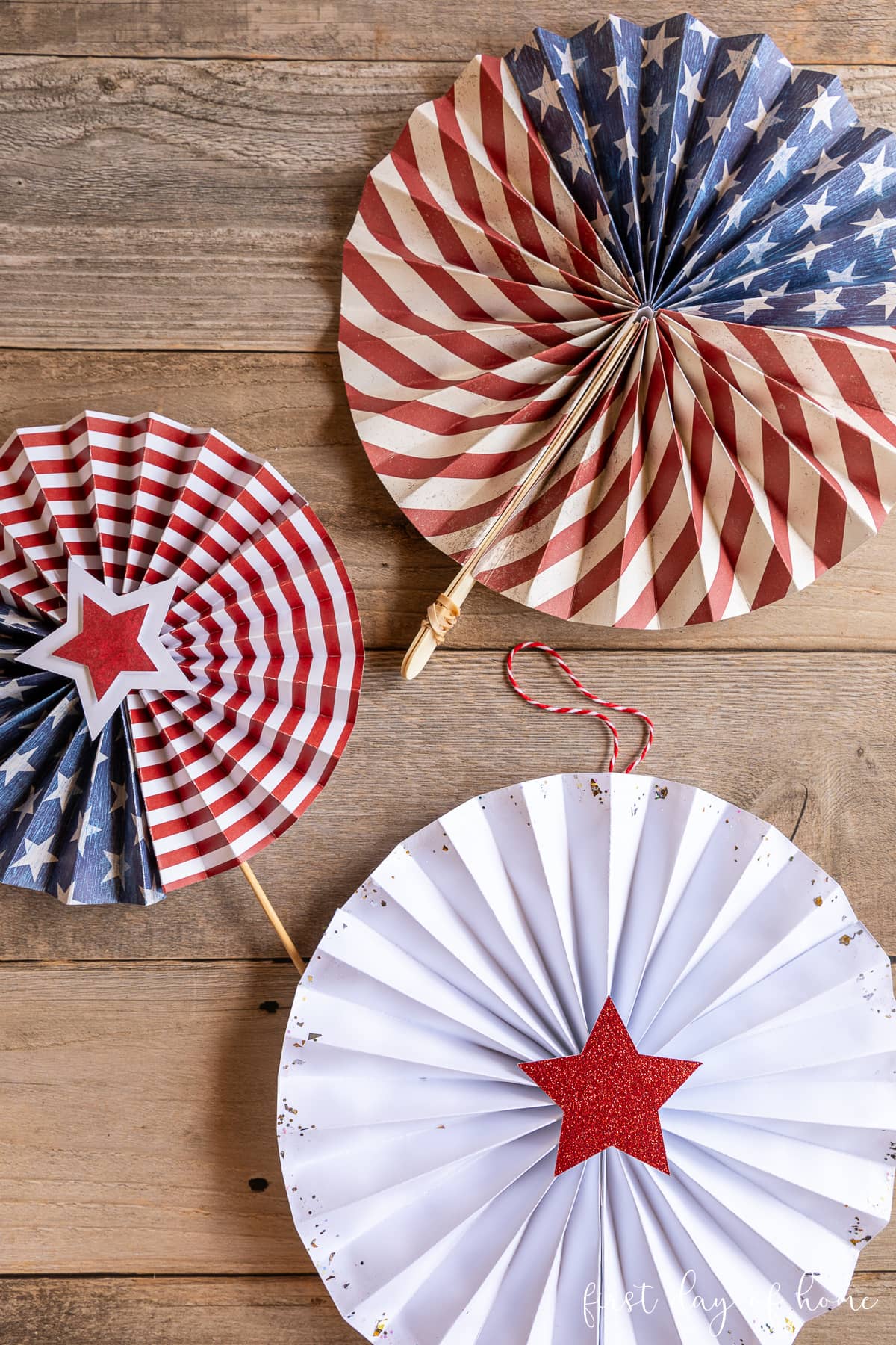 Paper fans with wooden skewer, popsicle sticks, and string for hanging