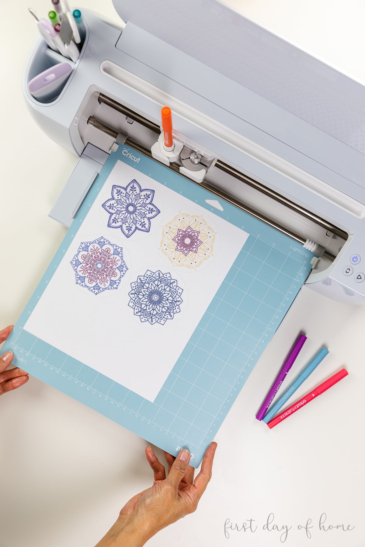 Unloading Cricut cutting mat with mandala designs drawn with Cricut infusible ink pens