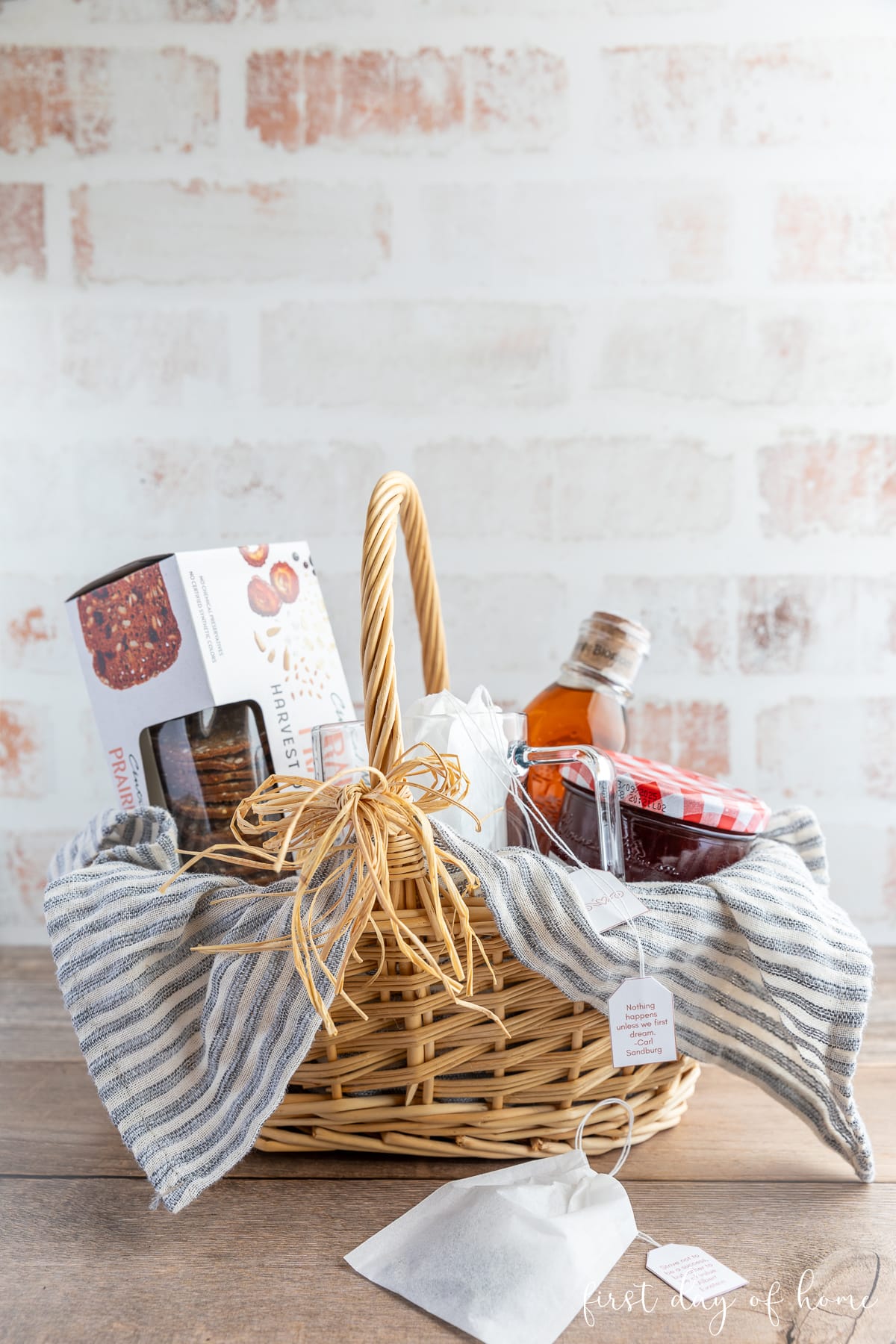 Straw basket filled with fruit preserves, crackers, honey, and homemade herbal tea using dried herbs