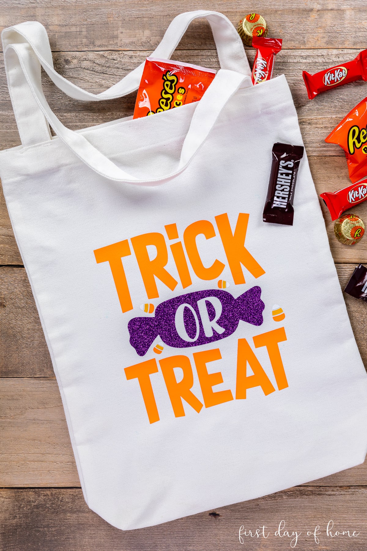 Halloween DIY trick or treat bag made with Cricut vinyl, shown with Halloween candy.