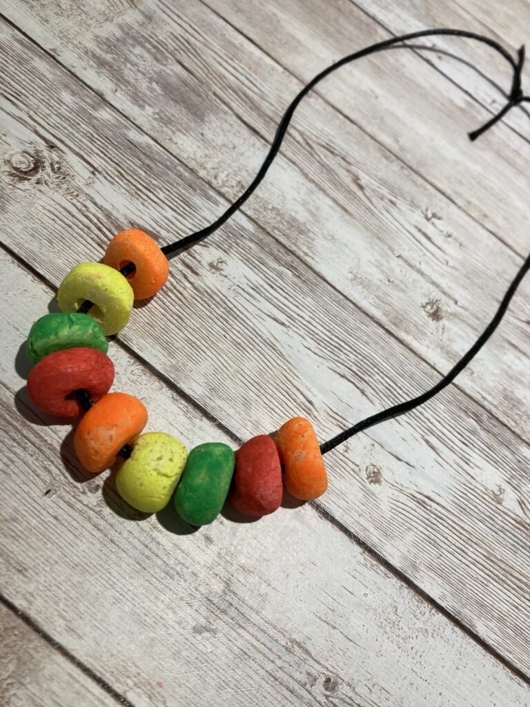 Painted salt dough beads on a string.