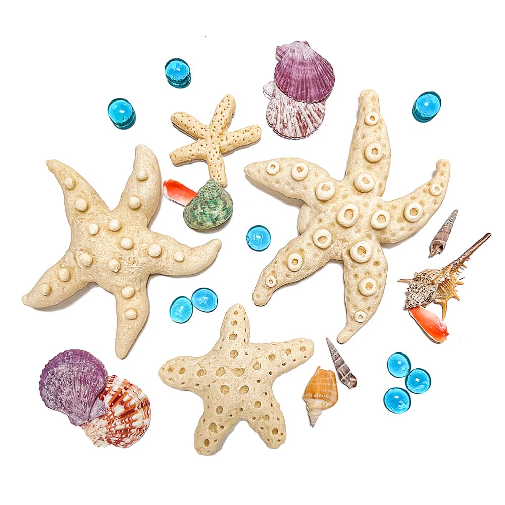 Sea stars made from salt dough, shown with shells and beads.