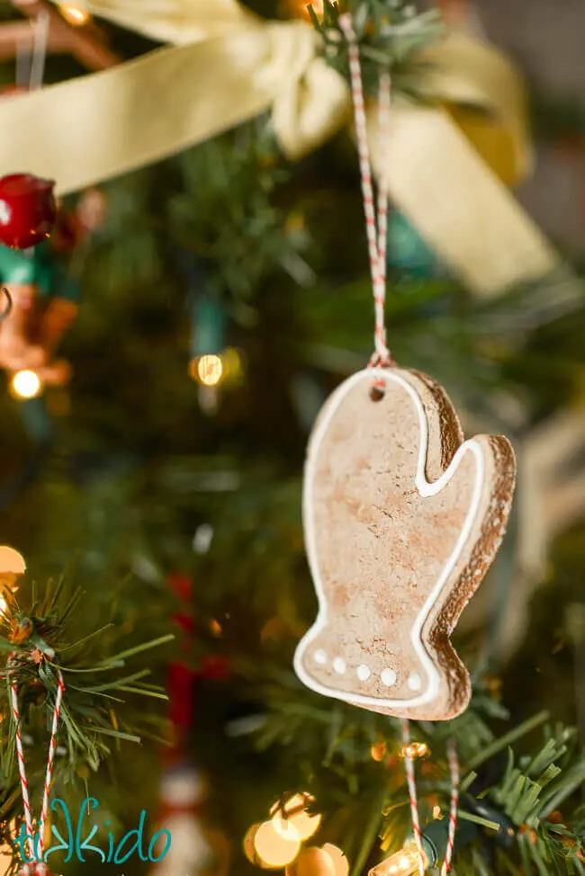Salt dough gingerbread mitten ornament hanging on Christmas tree.