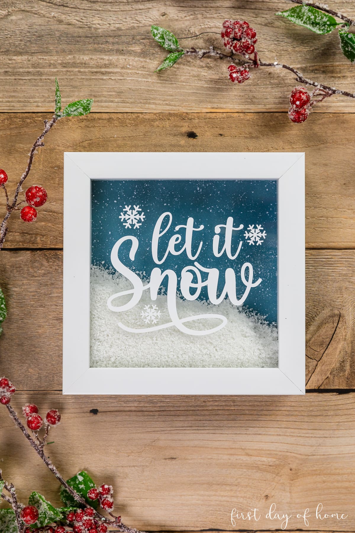 "Let it Snow" Christmas shadow box with Cricut decal filled with faux snow.