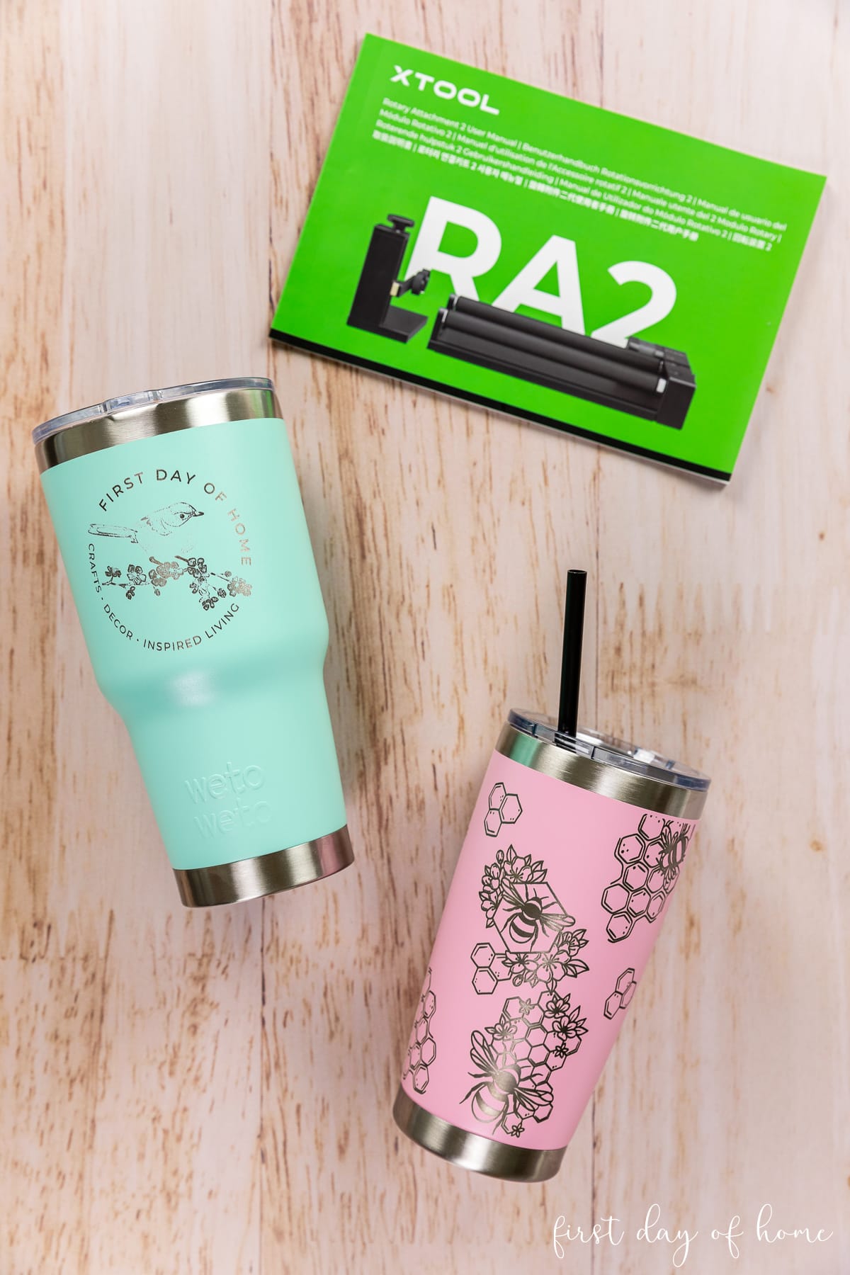Two laser engraved tumblers shown with RA2 Pro instruction manual.