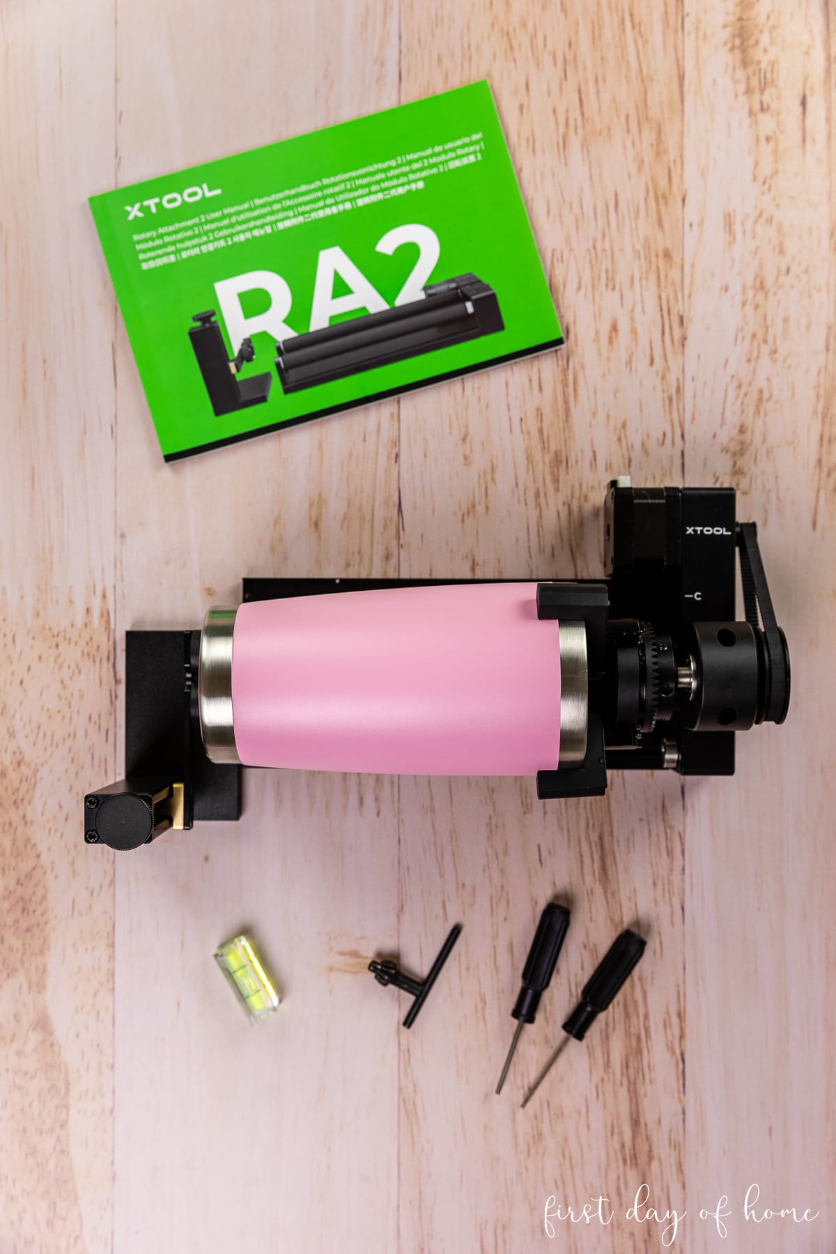 Supplies for laser engraving tumblers, including the RA2 Pro Rotary Attachment and a powder-coated tumbler.
