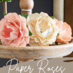 Group of paper roses on tiered tray. Text overlay reads "Paper Roses Easy Tutorial".