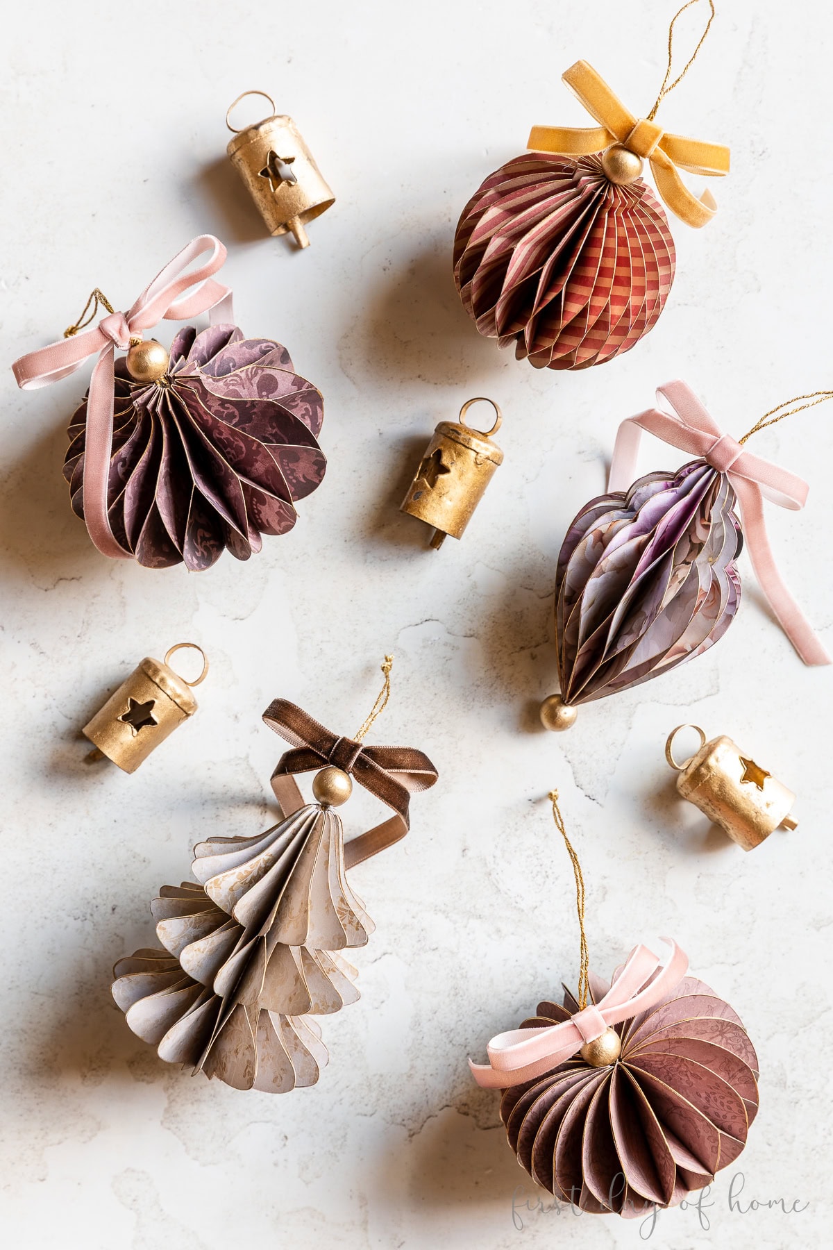 Honeycomb paper Christmas ornaments in various shapes, including a Christmas tree, round ball, bulb, heart, and finial.