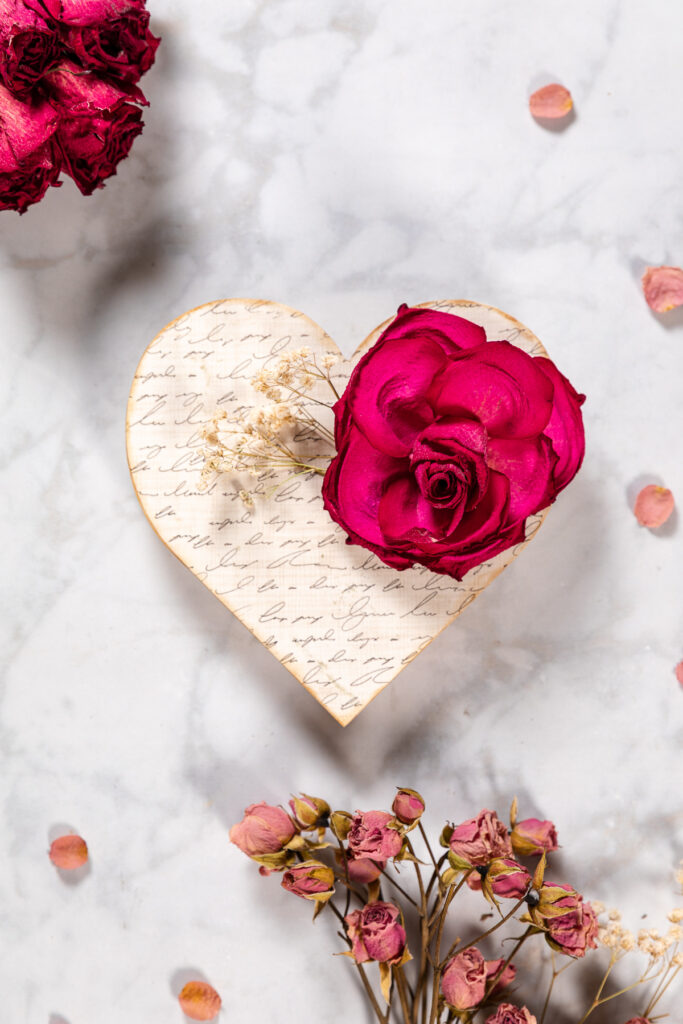 Wood heart decorated with decoupage paper and dried flowers.