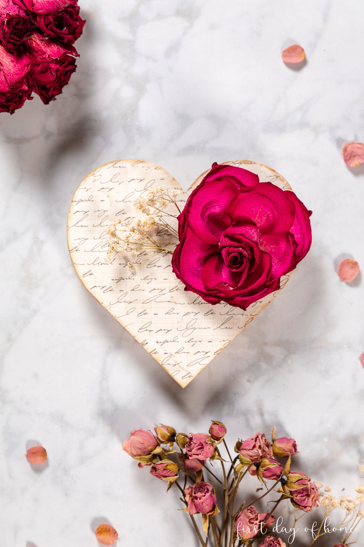 Decoupage wood heart with dried flower accents.