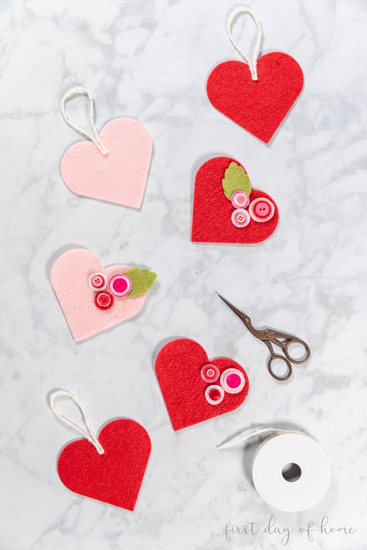 Heart-shaped felt ornaments with button flower accents.